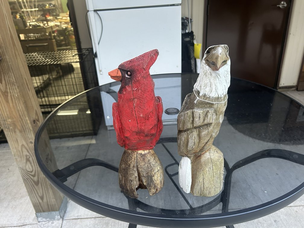 Two chainsaw carved birds each about 14" tall.
