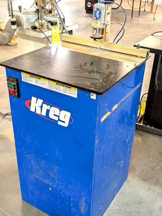 Kreg brand drilling table is Model DK1100 FE, has a 24" table and foot pedal control.