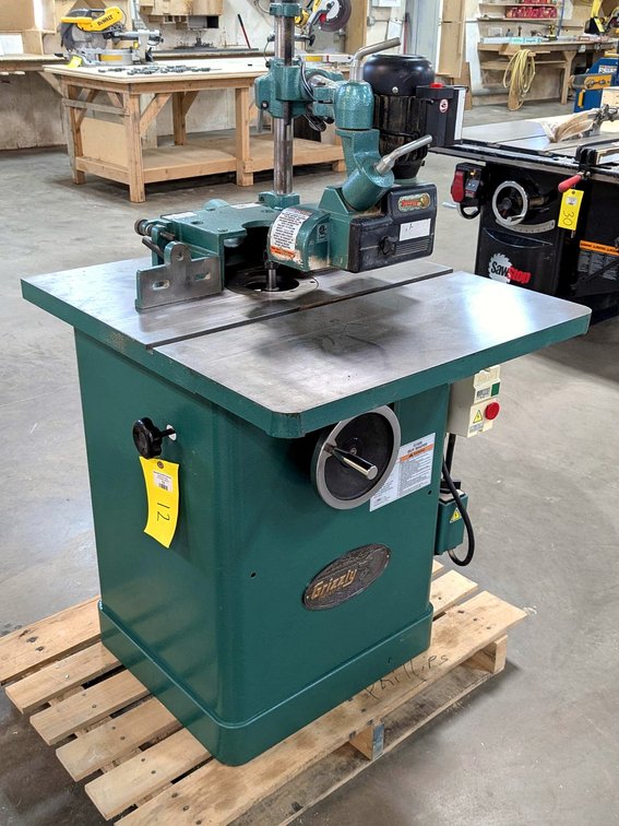 Grizzly industrial grade 3 hp shaper is Model G1026 and has a Grizzly automatic feed system.