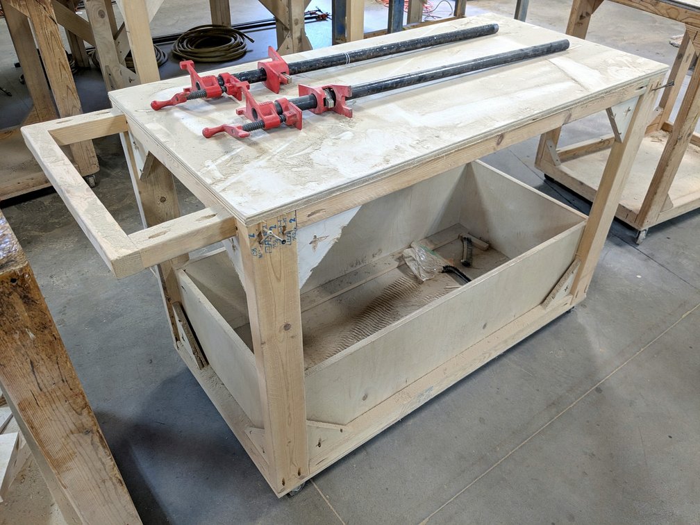 4' rolling work bench is about 2' x 3' high, handle adds another 7-1/2".