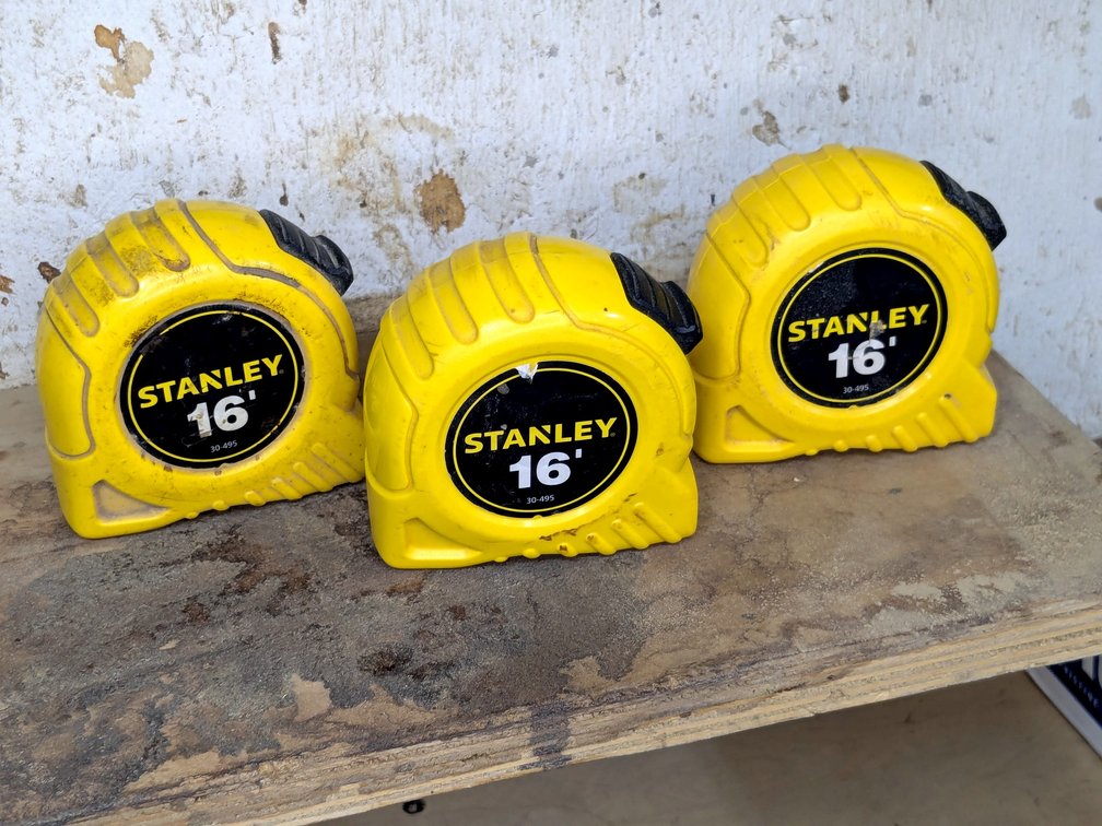 Three Stanley 16' tape measures.