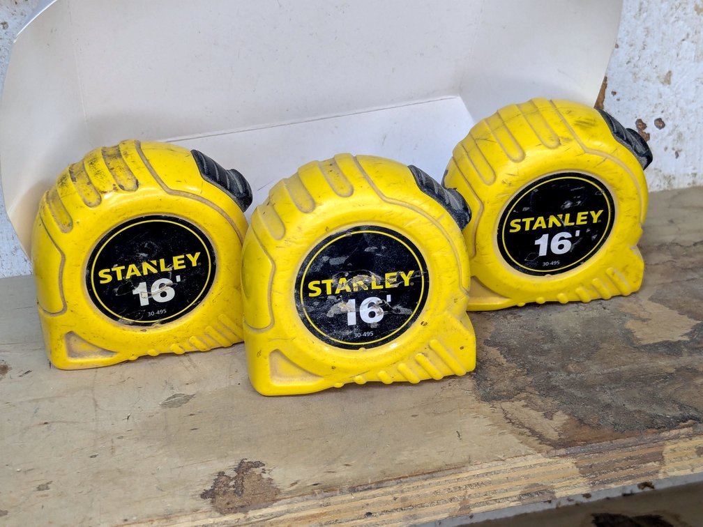 Three Stanley 16' tape measures.