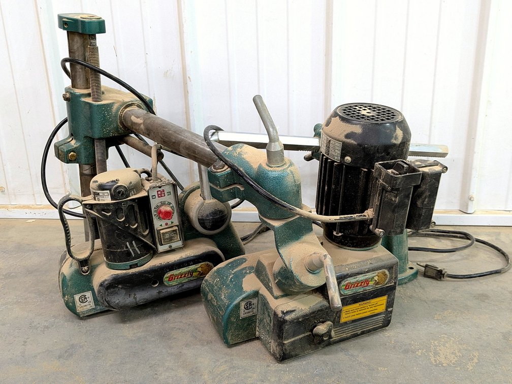 Pair of Grizzly automatic feeders for parts or repair.
