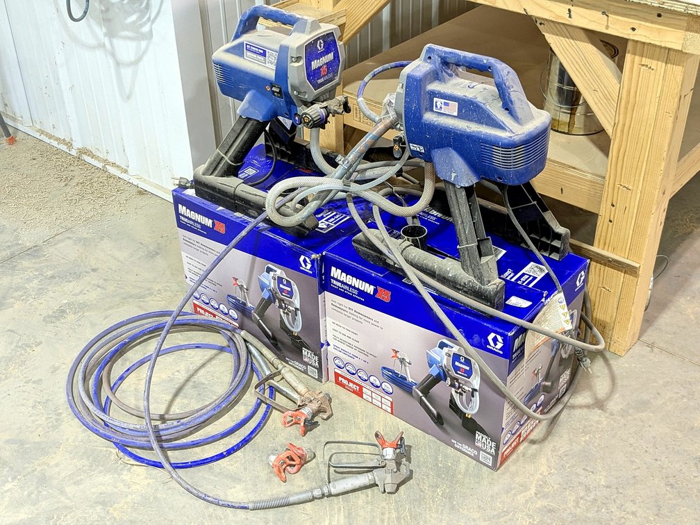 Pair of Magnum X5 airless paint and stain sprayers come with hoses and original boxes.