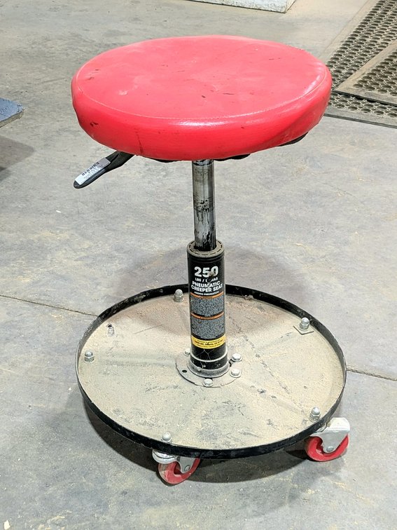 Rolling shop stool measures 16" tall collapsed, adjustable height works.