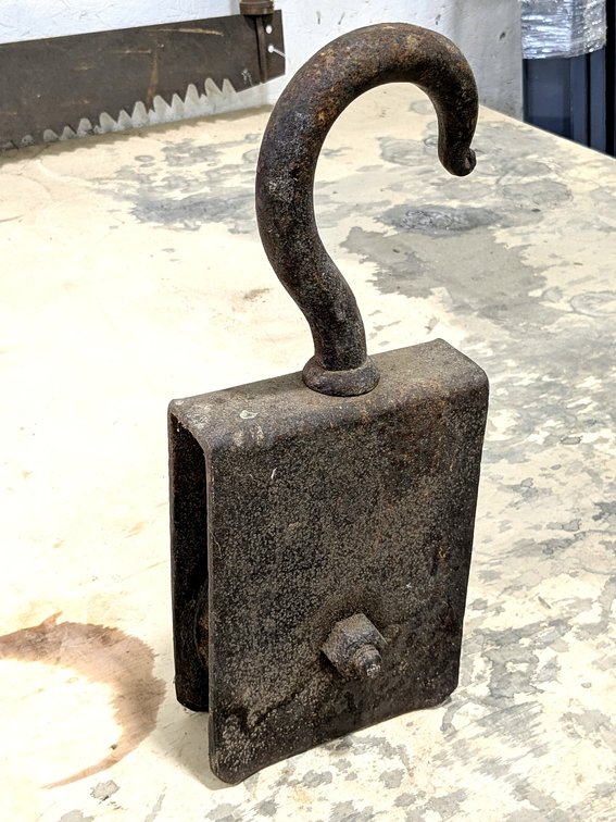 Antique pulley with a forged hook measures 16" tall.