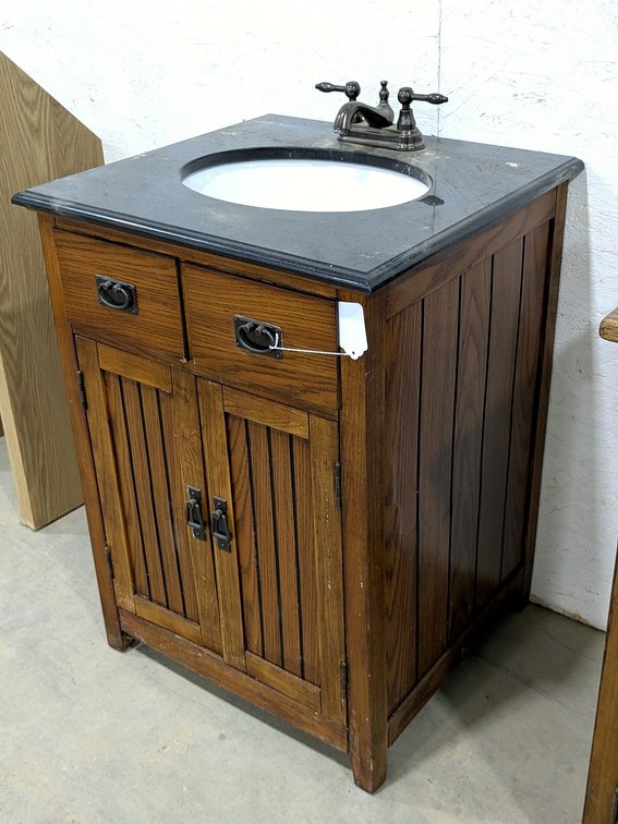 Bathroom vanity with top and sink measures 24" wide x 22" x 33" tall.