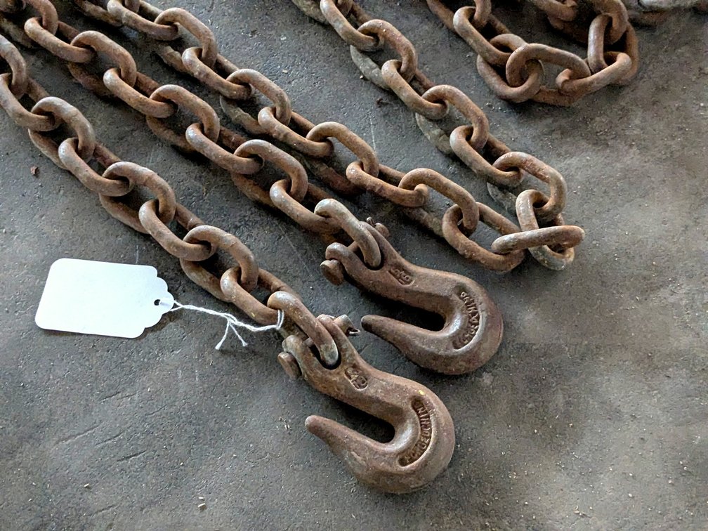 Approx 15' of 5/16" chain with grab hooks, no repairs noted.