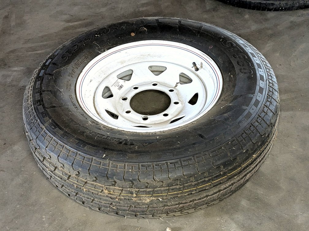 Trailer spare tire with an 8x6-1/2" bolt pattern and 5" center hub.