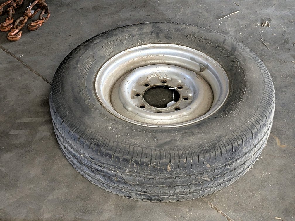 Trailer spare tire with an 8x6-1/2" bolt pattern and a 4-7/8" center hub.
