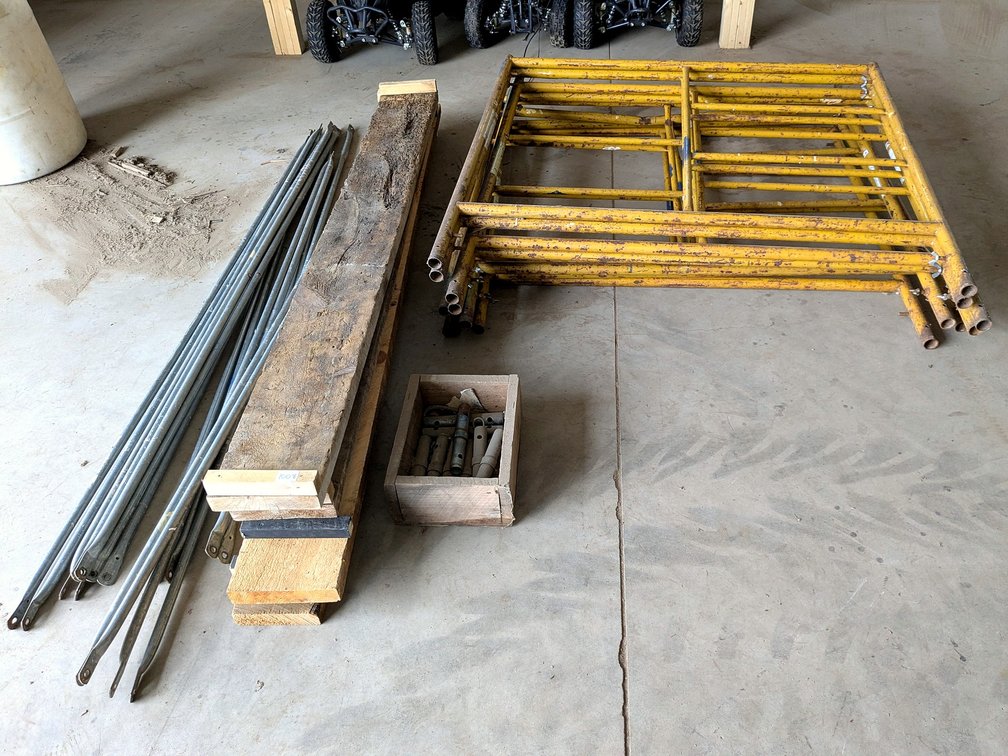 Four rings of scaffolding with braces and planks.
