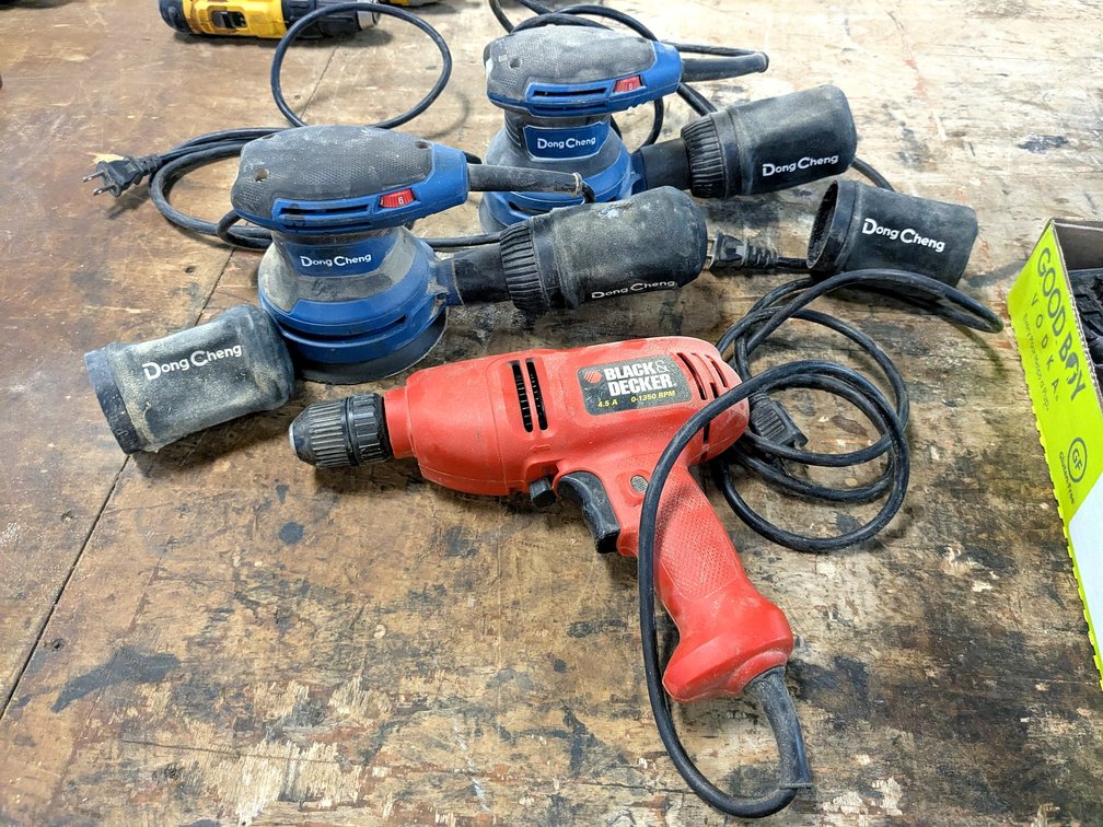Black & Decker corded drill and two 5" random orbital disc sanders with extra dust bags.