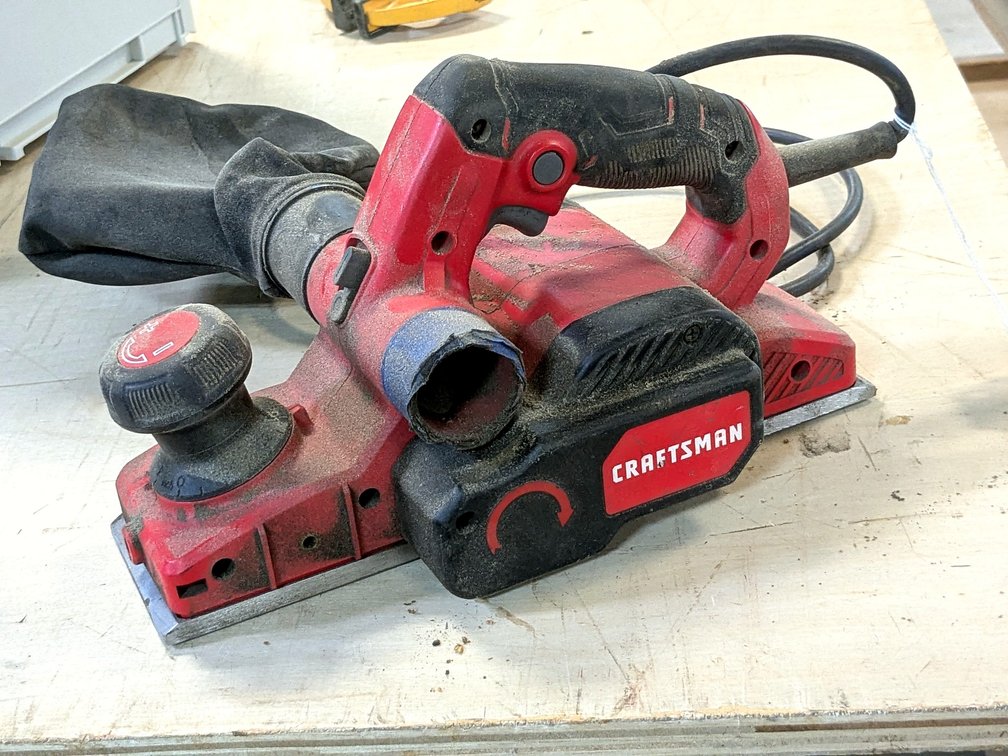 Craftsman 3-1/4" planer with two dustbags.