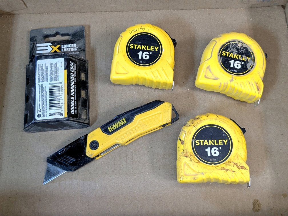 DeWalt folding utility knife with full package of extra blades and three 16' Stanley tape measures.