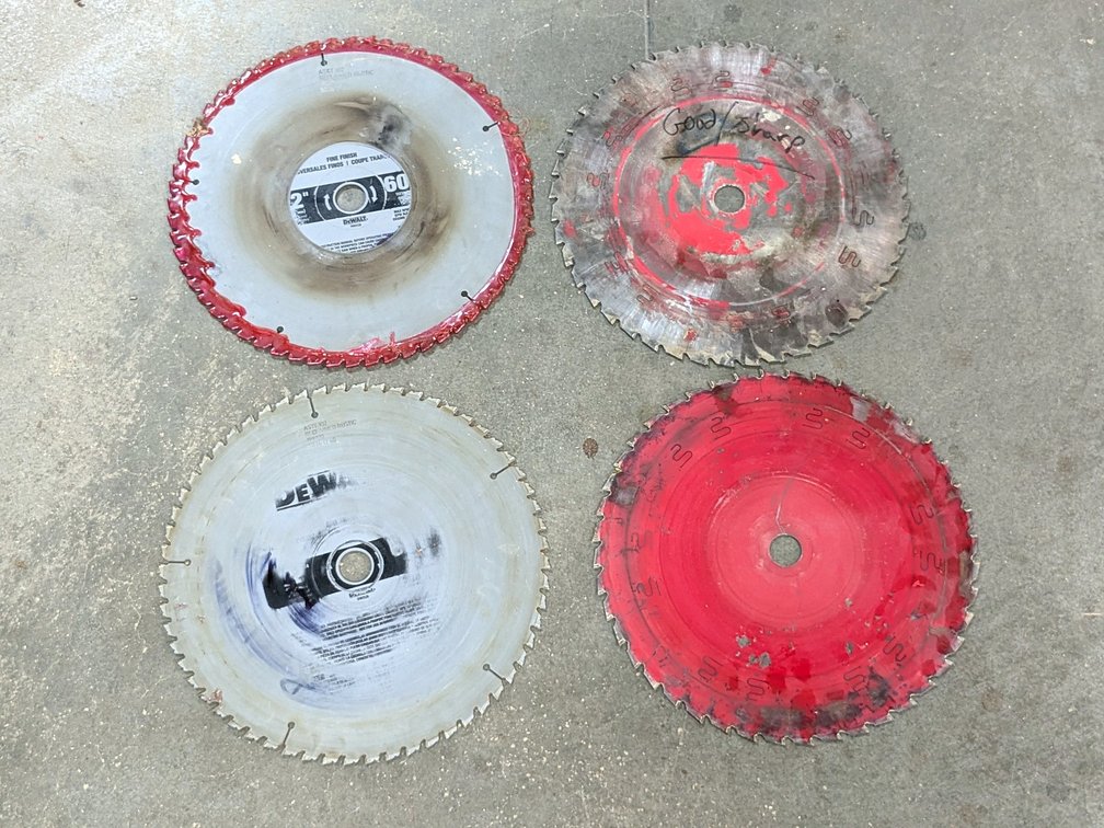 Four 12" circular saw blades with carbide tipped teeth.