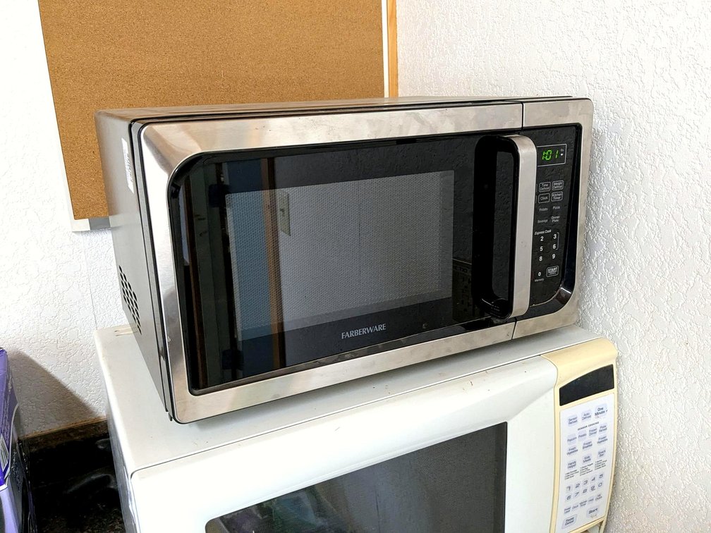 Farberware microwave measures about 19" x 11" x 15" over cabinet.  Works.