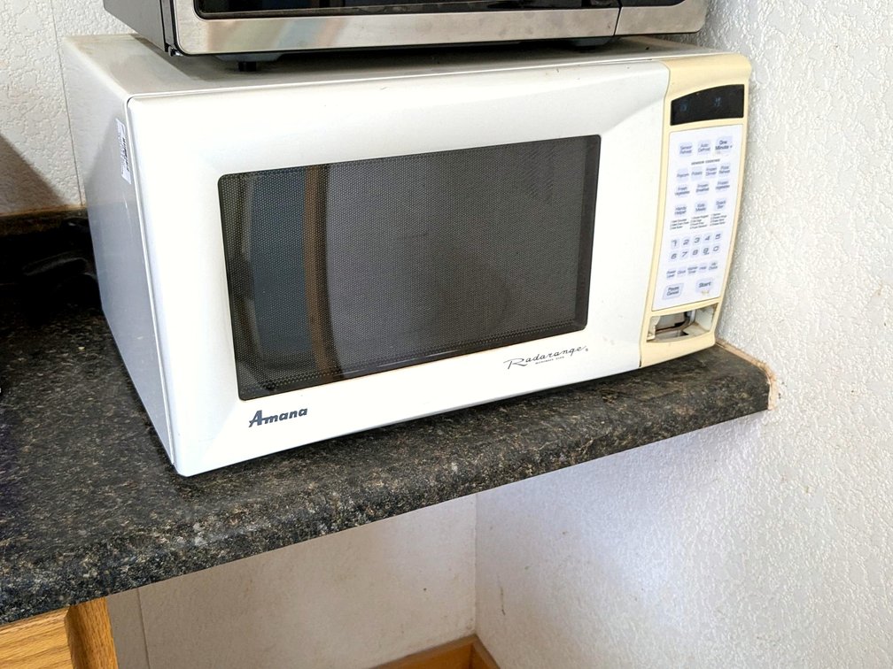 Amana Radarange microwave measures about 22" x 16" x 12" high.  Works.