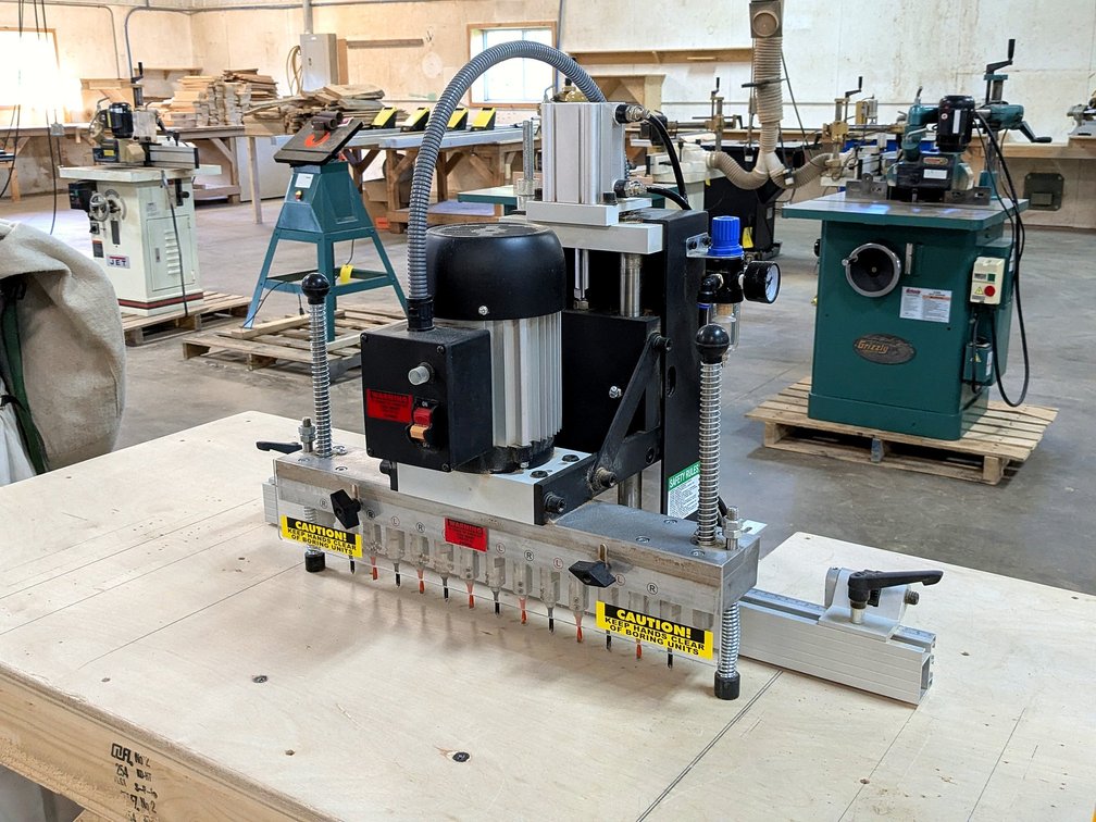 13 spindle pneumatic boring machine is Model LBP13.  Table measures 62" x 28" x 3' tall.
