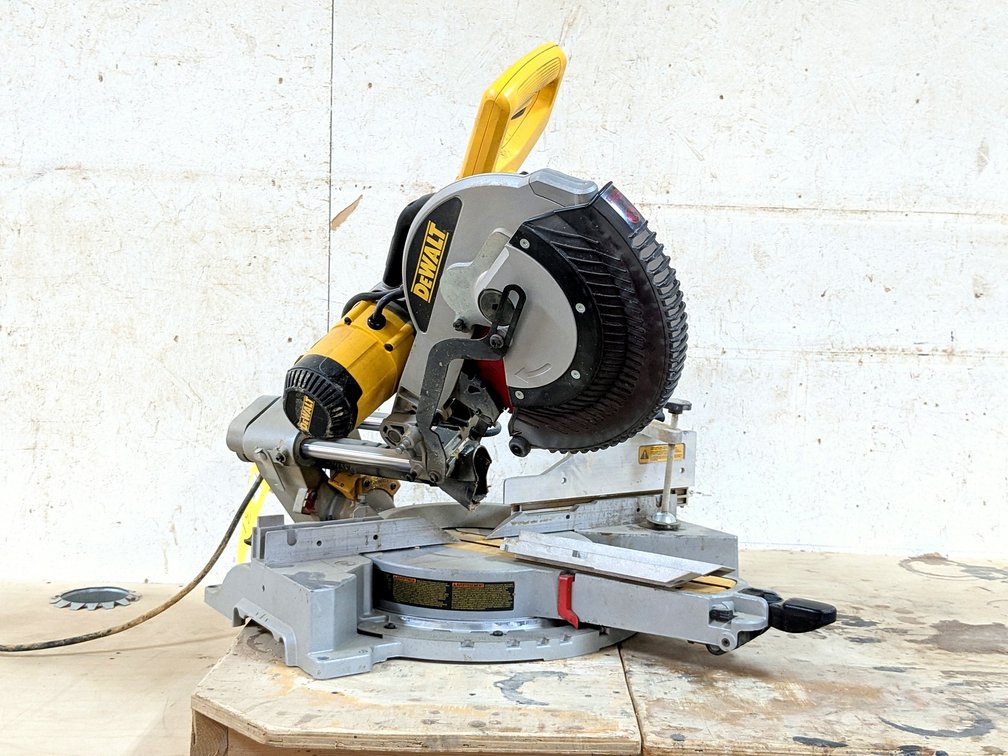 DeWalt DWS780 sliding compound miter saw with a 25" aluminum table and Diablo blade.