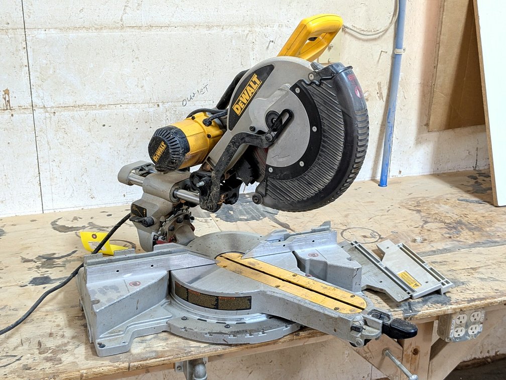 DeWalt DWS718 sliding compound miter saw with a 25" aluminum table and Diablo blade.