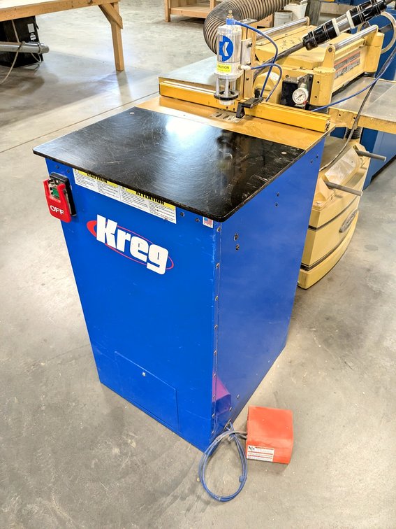 Kreg brand drilling table is Model DK3100, has a 24" table and foot pedal control.