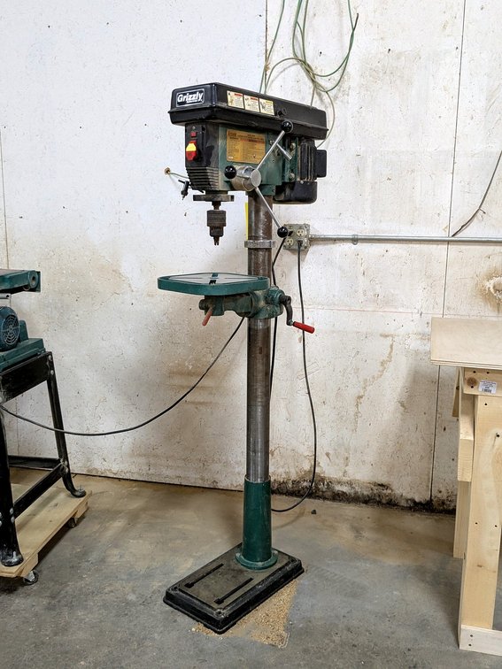 Grizzly Industrial drill press with a 11" table, 3000 max rpm, 140 min rpm.  Unit stands 64" tall ov