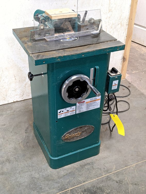 Grizzly industrial 1.5 hp shaper is Model G1035, has a 20" table.