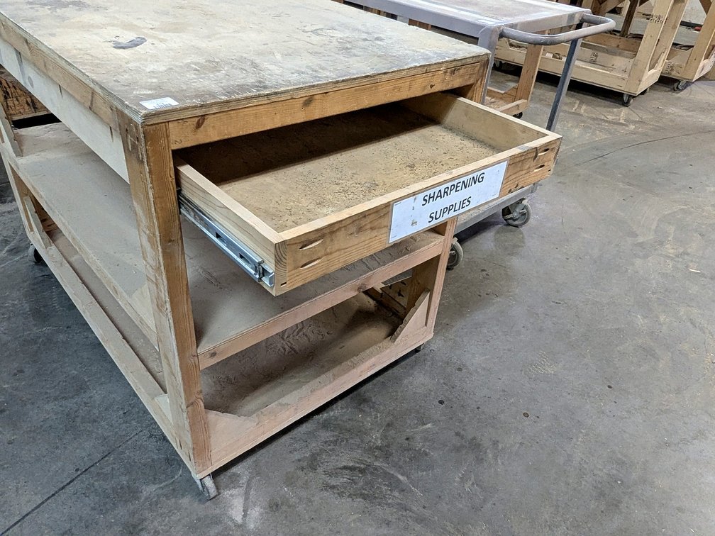 Wooden rolling shop cart is 48" long.