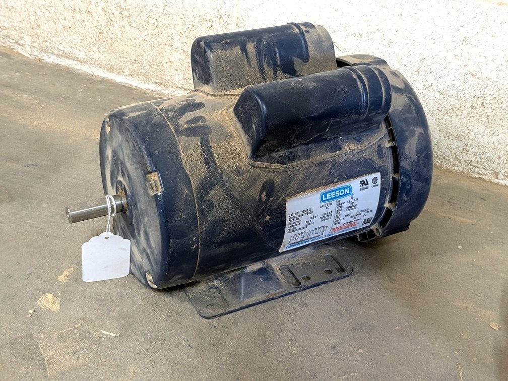 Leeson 1.5 hp electric motor with a 5/8" shaft and is marked 115/230 volt.