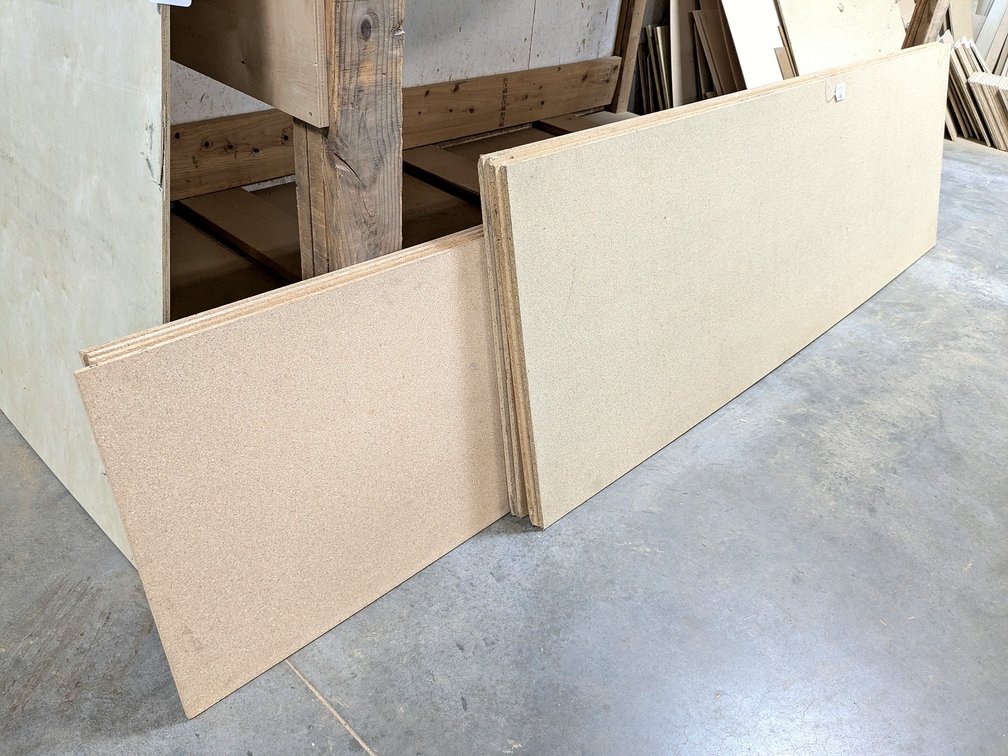 Particle board and 1/4" cabinet grade plywood, largest sheets are 4x8.