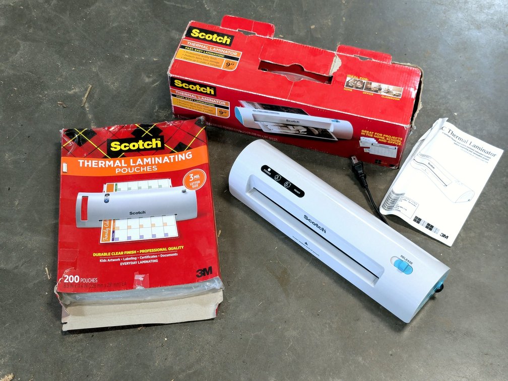 Scotch thermal laminator with laminating pouches.