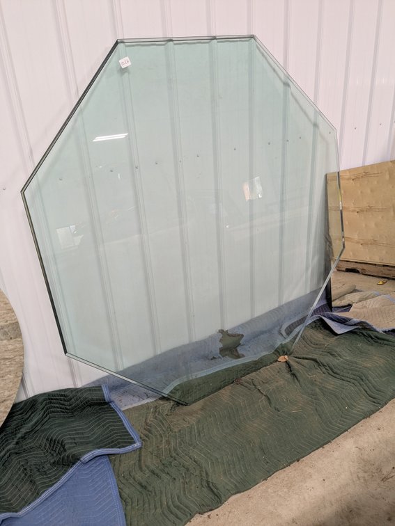 Octagonal glass table top measures 68" across. Glass is 3/4" thick.