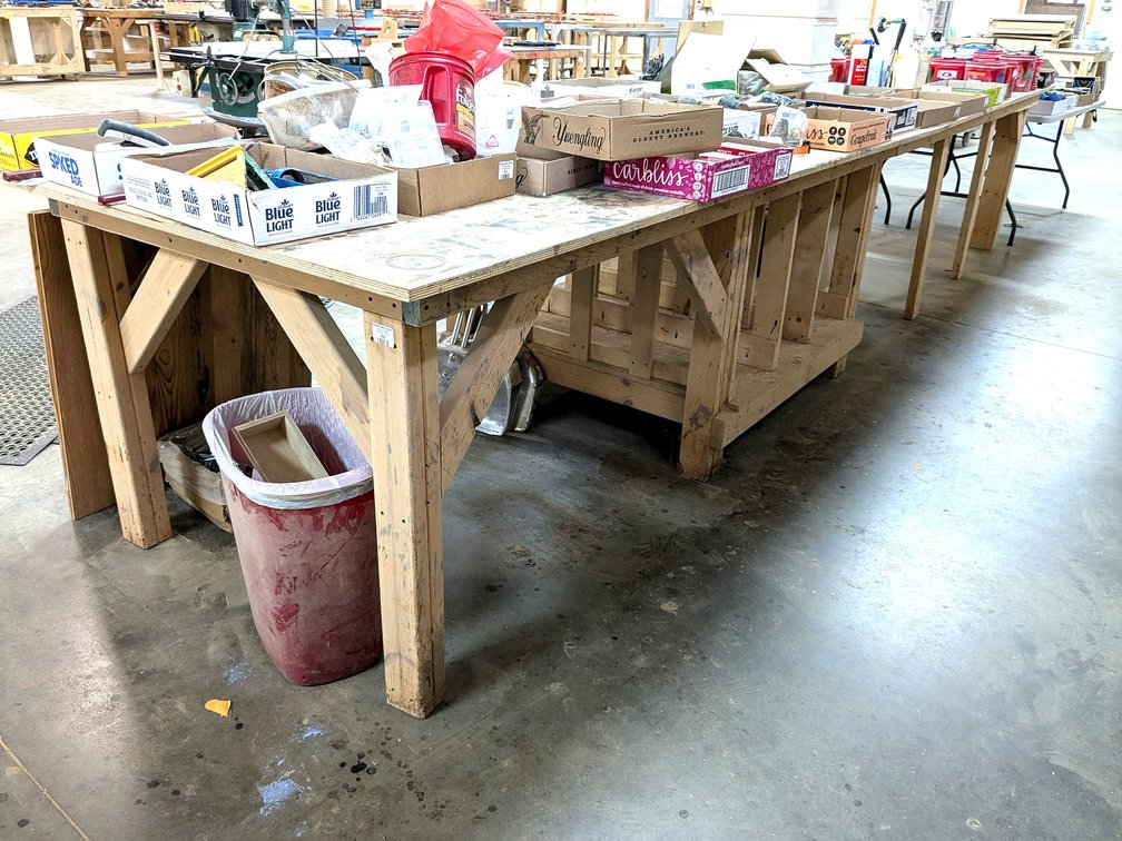 Heavy duty wooden work bench measures 4' wide x 16' long x 35" high.  Please bring tools and help to