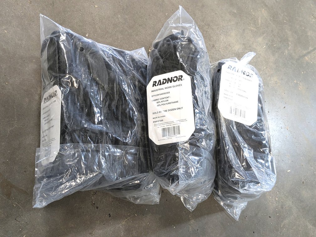 Three unopened packages of Radnor industrial work gloves.