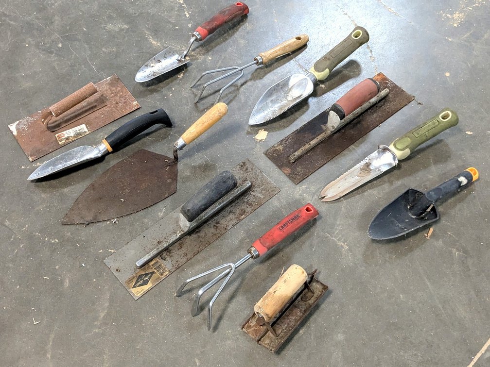 Several masonry trowels, garden trowel or spade and more.