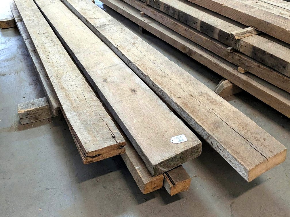 Several rustic wooden planks up to 10" x 3" x 13' long.