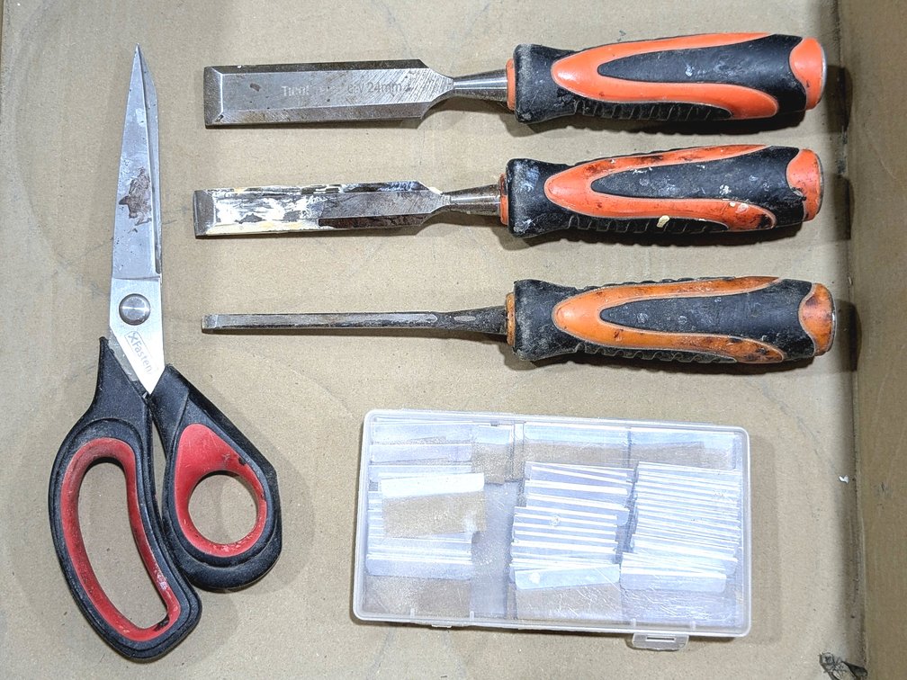 Wood chisels, scissors, and razor blades.