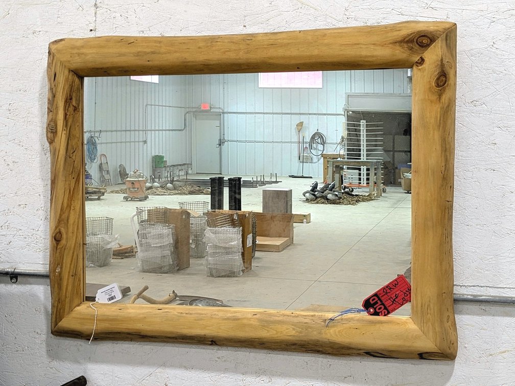 Rustic wood framed mirror measures 40" x 30" over frame.