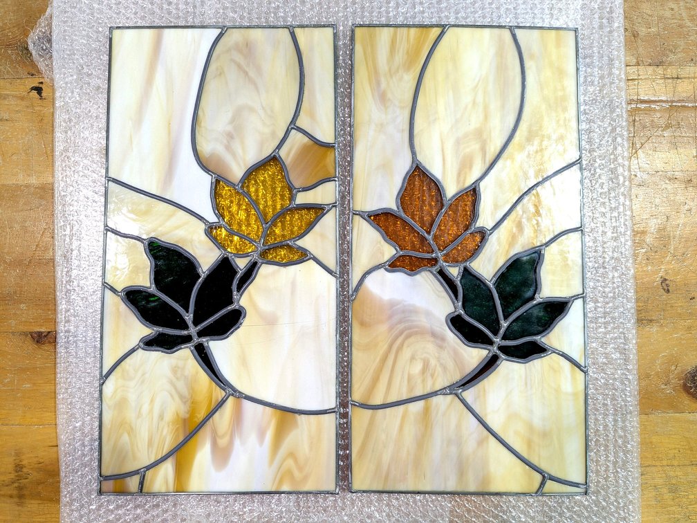 Two pretty leaded stained glass pieces are 20" x 10".