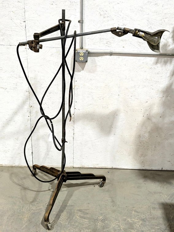 Vintage industrial work lamp is marked Woodward, Michigan and stands 5' tall.