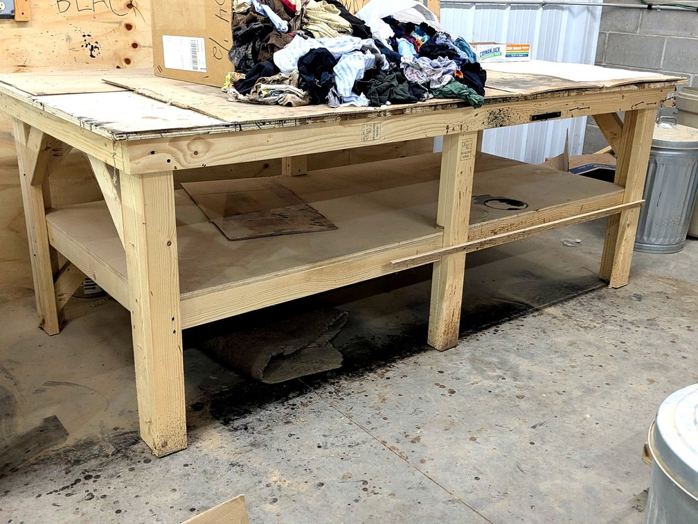 Sturdy 4' x 8' work bench is 3' high.