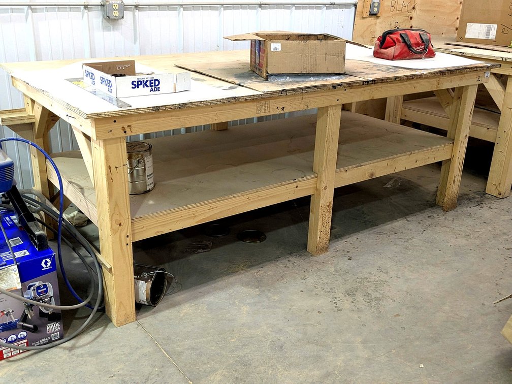 Sturdy 4' x 8' work bench is 3' high.