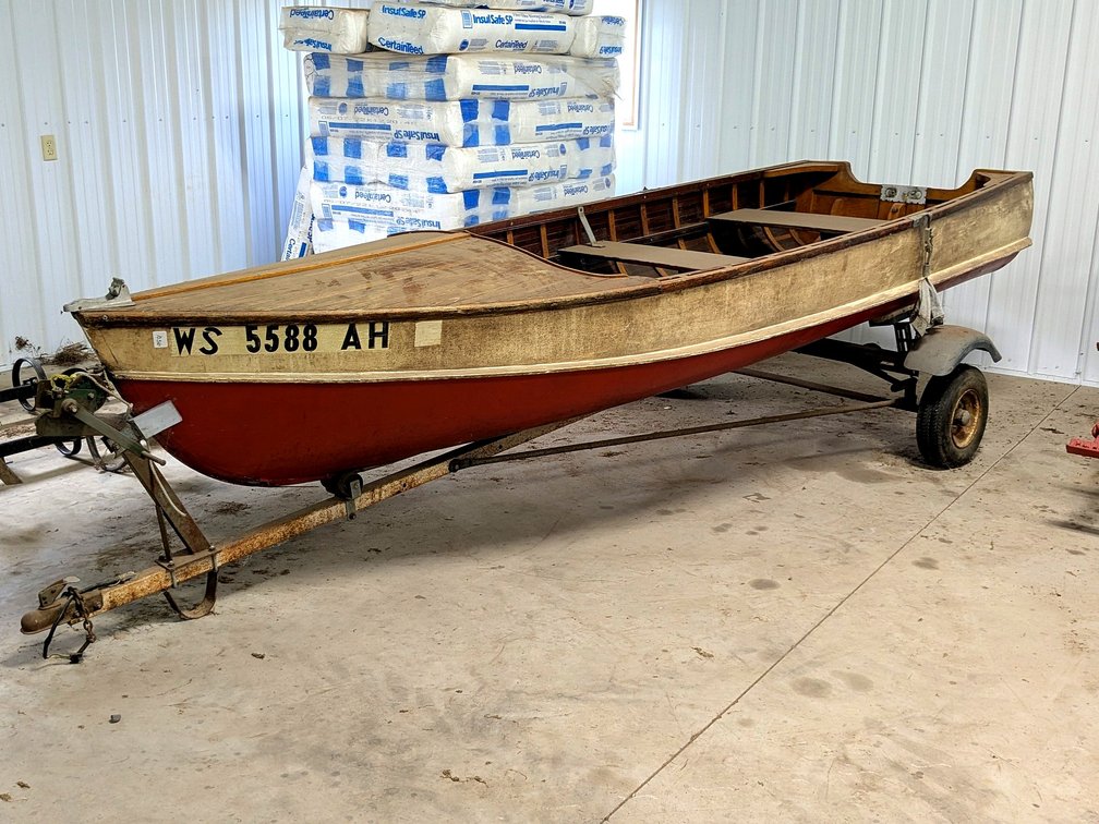 Classic wooden Rhinelander boat, measures 13-1/2' long, is in very good condition, and comes with a trailer.