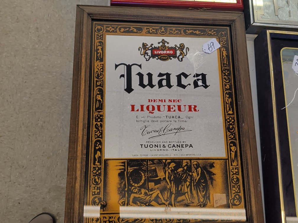 Tuaca liquor sign