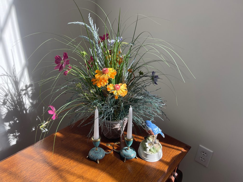 Candlestick Holders, Bluebird Figurine, and Floral Arrangement