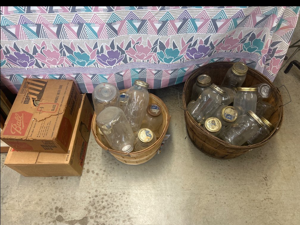Glass Mason Jars, Wooden Bushel Baskets, and Shipping Cartons full of Mason Jars