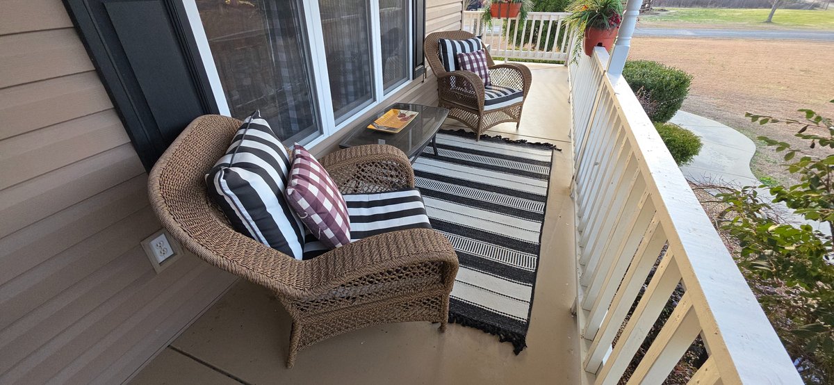 Outdoor Wicker Chairs with footstools, Table, Rug, and Cushions