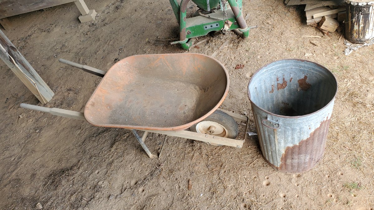Wheelbarrow and Metal Trash Can