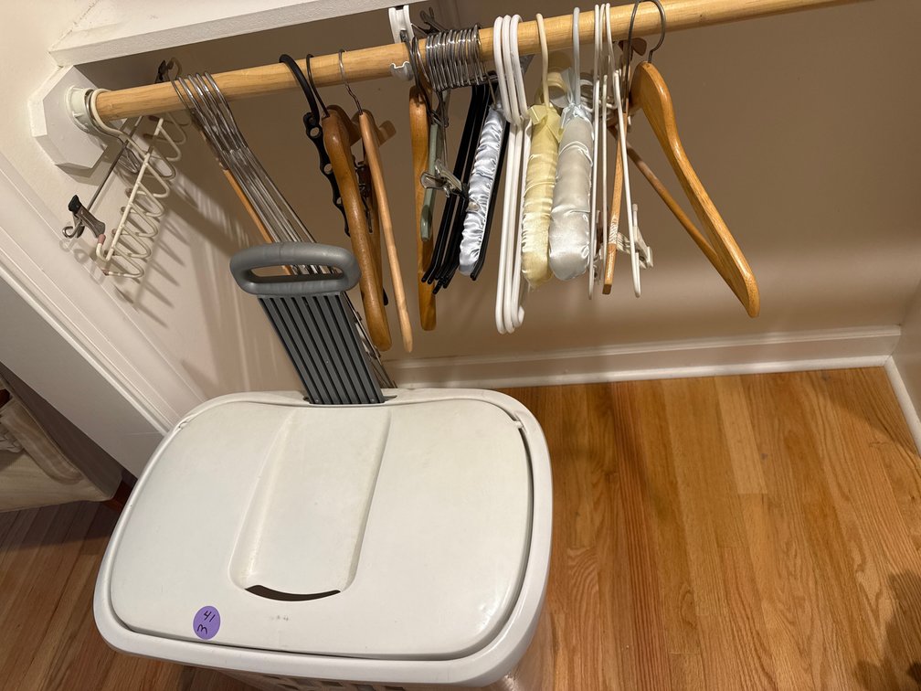 Large lot of laundry supplies hamper, hangers