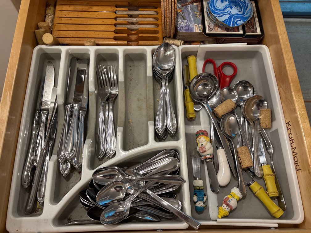2 Cabinet Lot (silverware, place mats) contents
